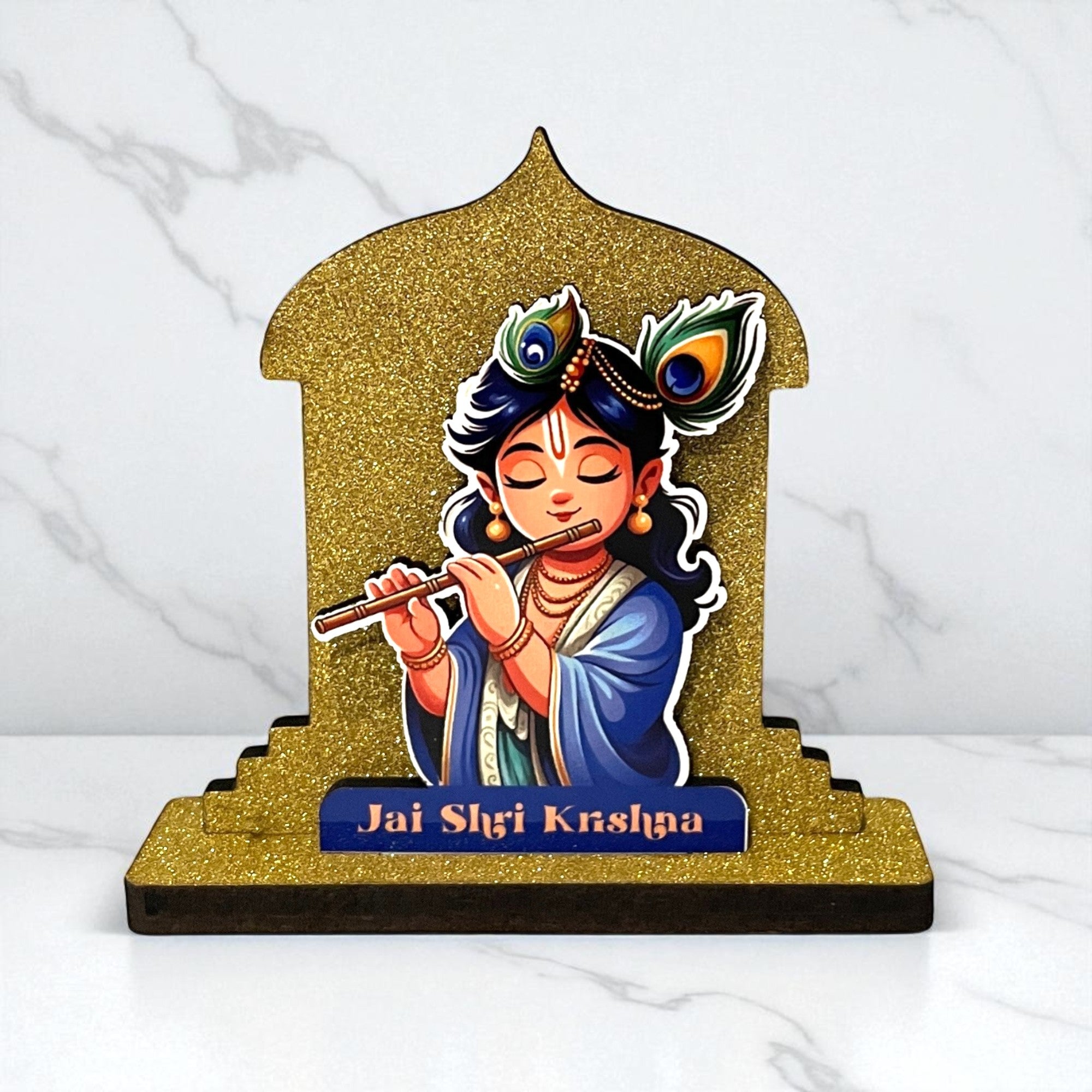 The Hindu Gods Mini Temple is a glittery golden stand with a cartoon-style Lord Krishna playing flute, peacock feather in hair, and "Jai Shri Krishna" on the base. Ideal for car dashboard or home décor.