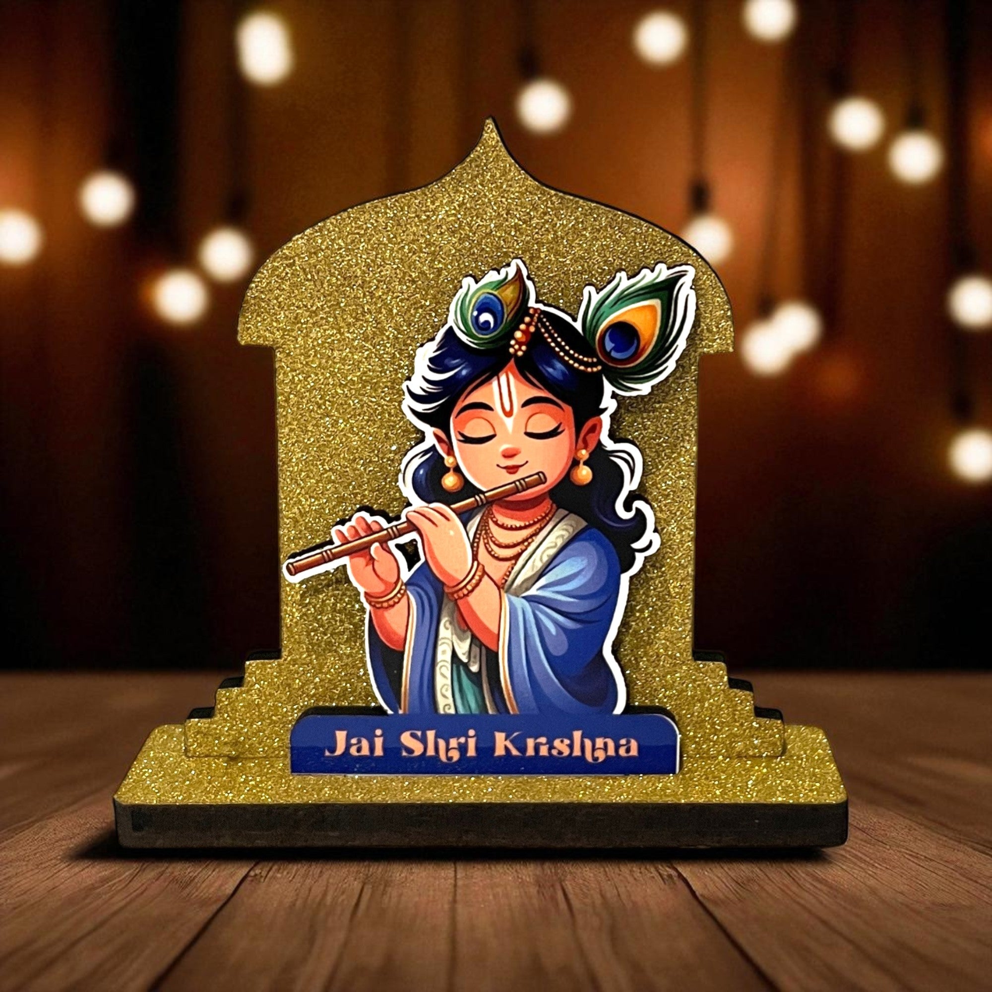 The Hindu Gods Mini Temple features Lord Krishna playing a flute, adorned with peacock feathers and set against a gold arch. "Jai Shri Krishna" is inscribed on the base, making it ideal for a miniature temple or car dashboard.
